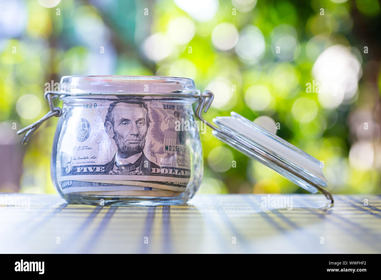 American banknote in glass jar Stock Photo - Alamy
