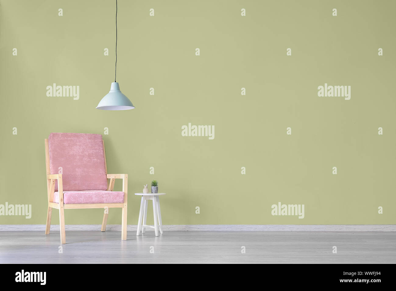 Interior of modern room with armchair, table and lamp Stock Photo - Alamy