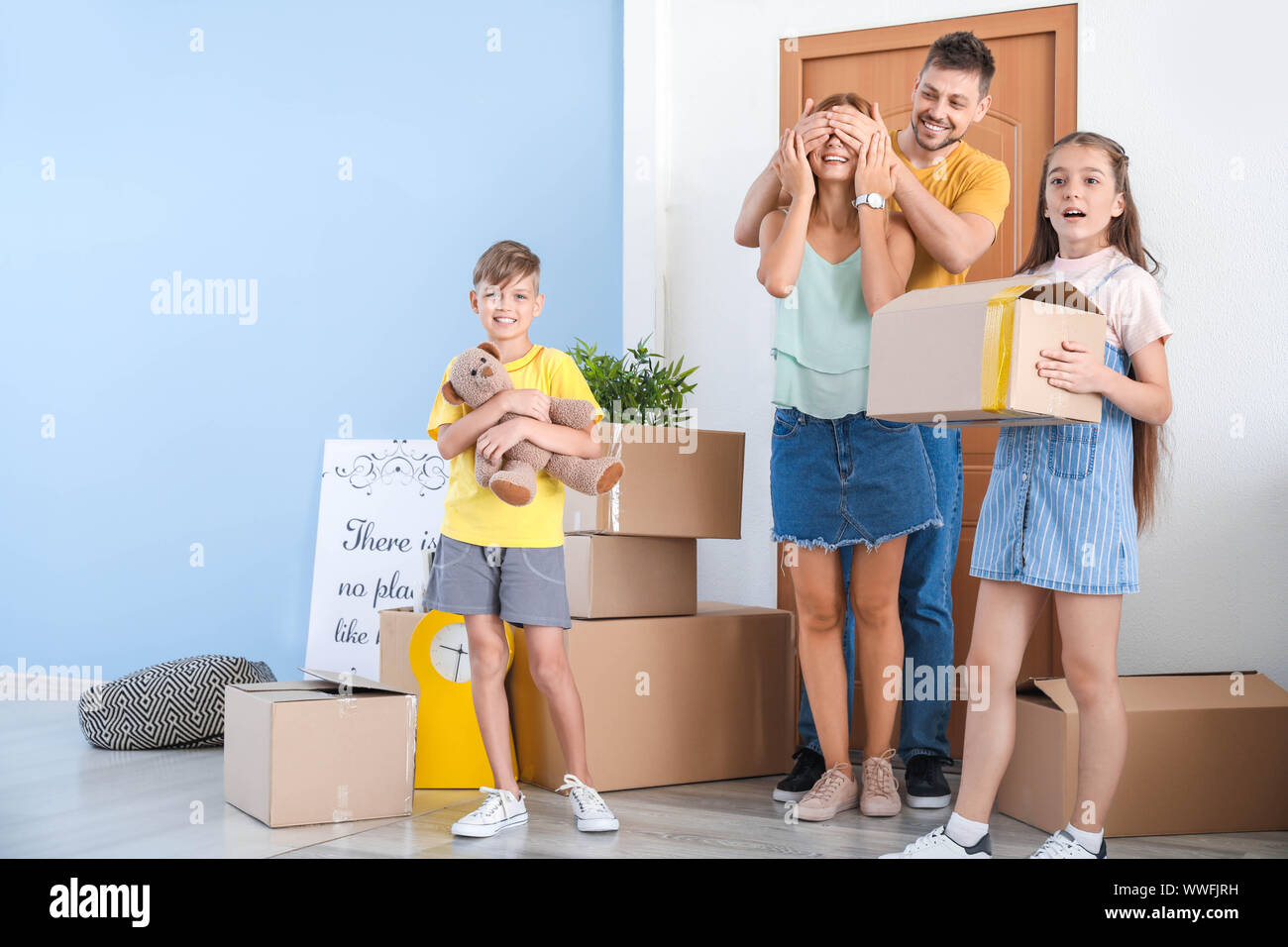 Happy family with belongings in their new house Stock Photo Alamy