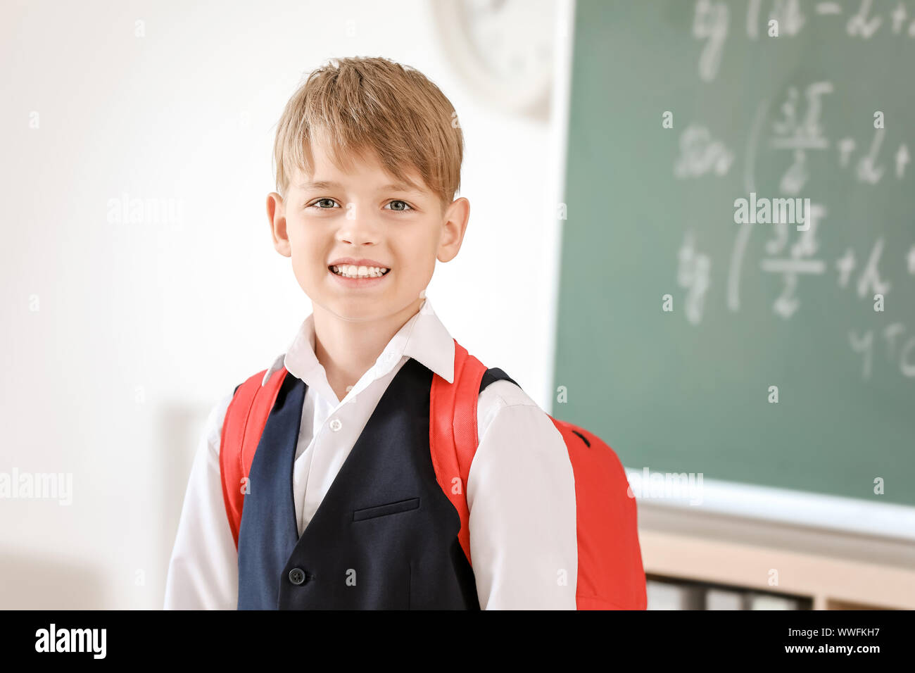 Cute little schoolboy in classroom Stock Photo - Alamy