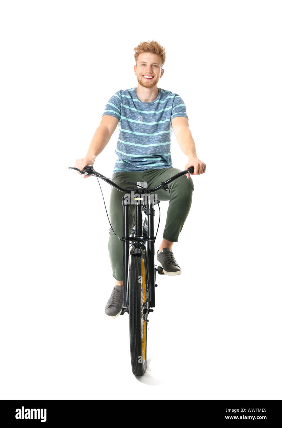 Young man riding bicycle against white background Stock Photo Alamy