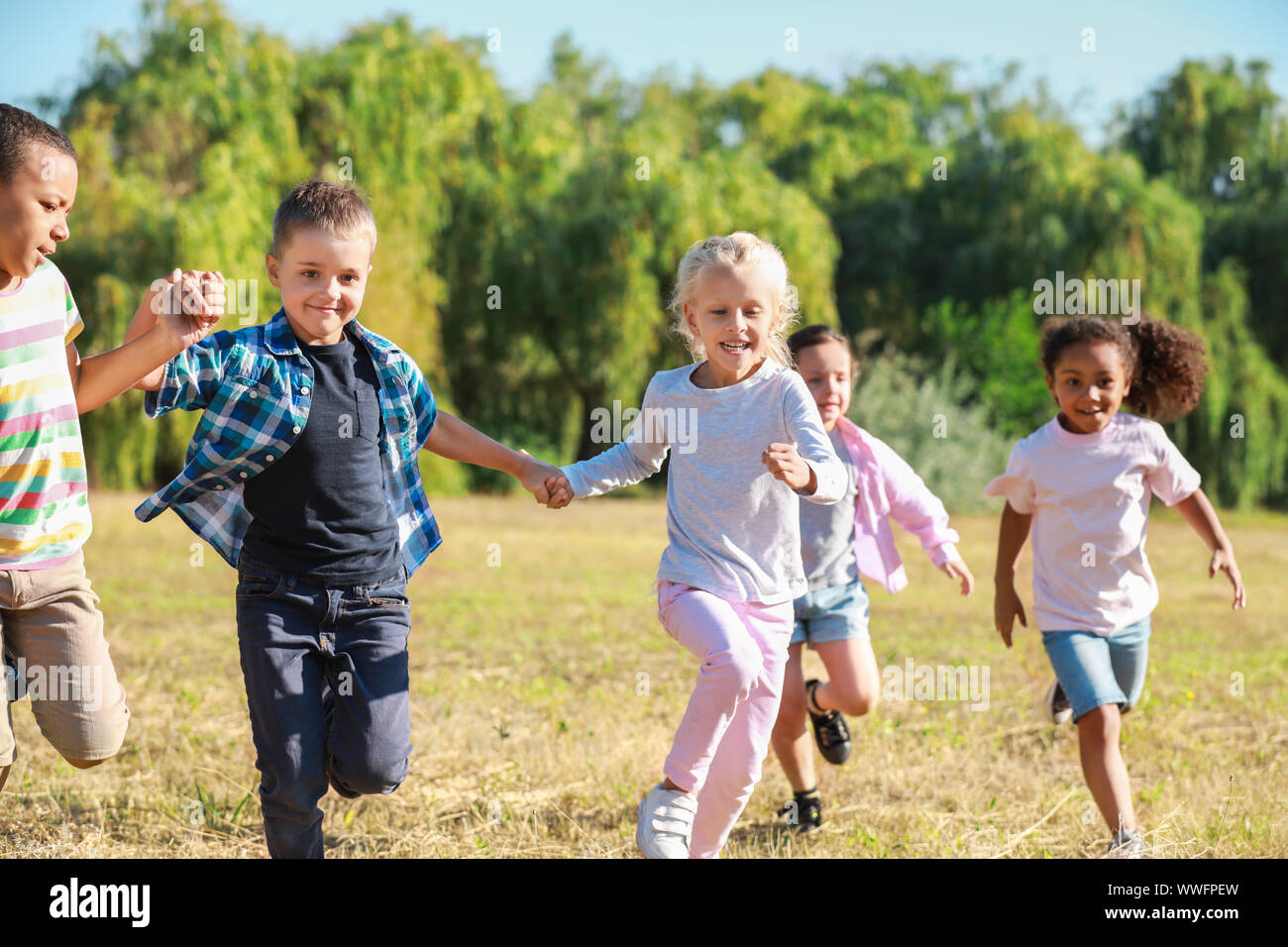 Group of running children in park Stock Photo - Alamy