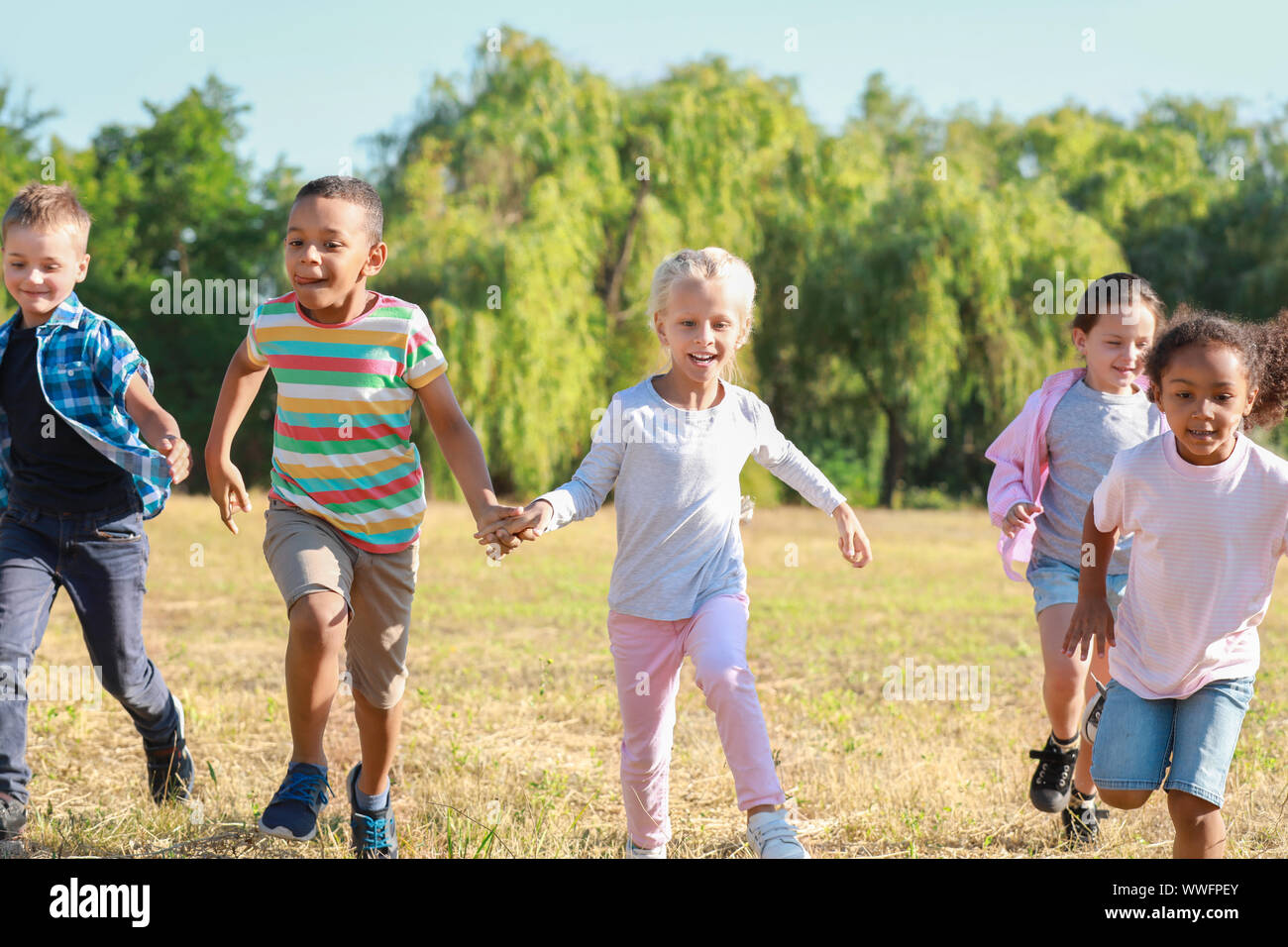 Group of running children in park Stock Photo - Alamy