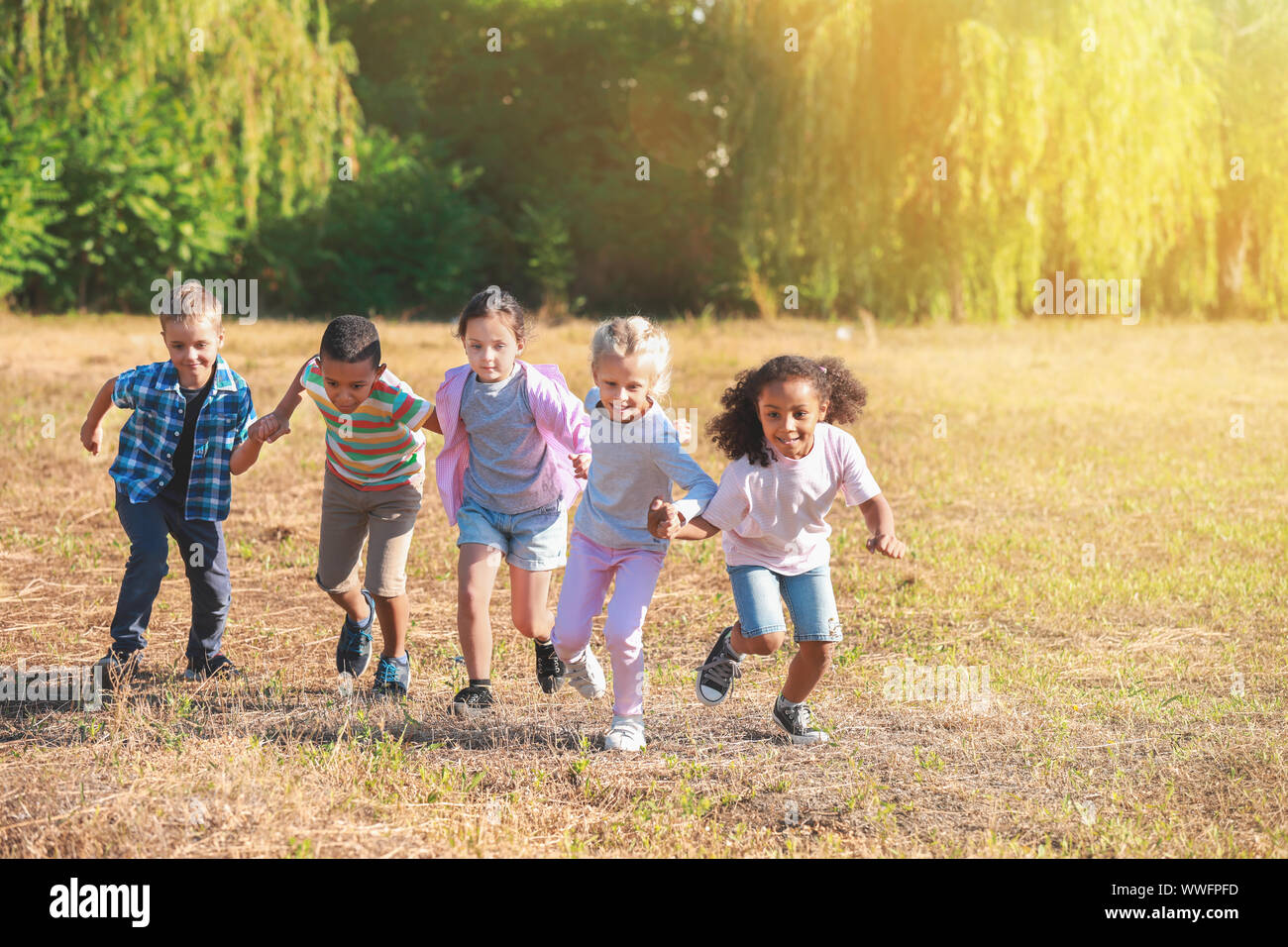 Group of running children in park Stock Photo - Alamy