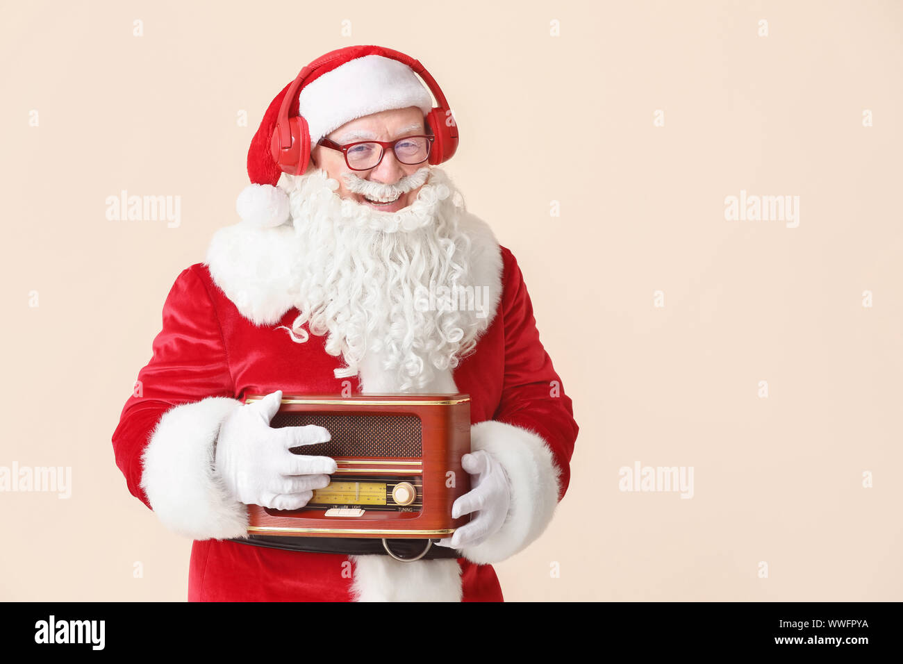 Portrait of Santa Claus with retro radio receiver on light background ...