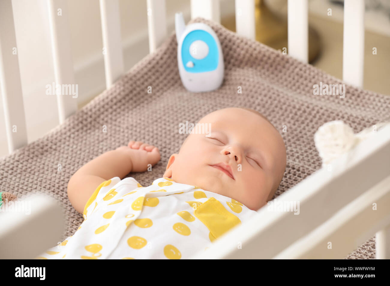 Modern Baby Monitor In Crib Of Cute Sleeping Infant Stock Photo