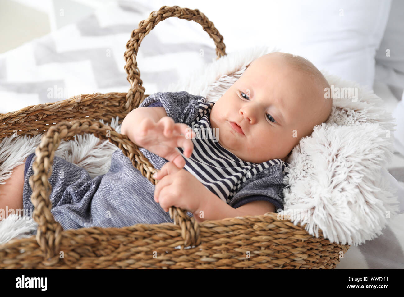 Adorable little baby in basket at home Stock Photo Alamy