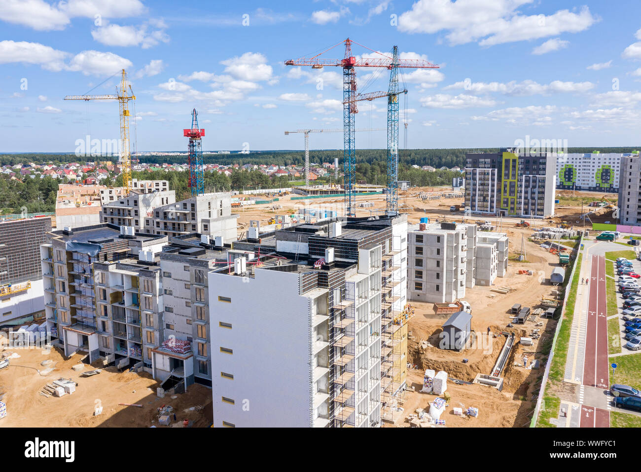 aerial view of newly built apartment buildings. tower cranes against ...