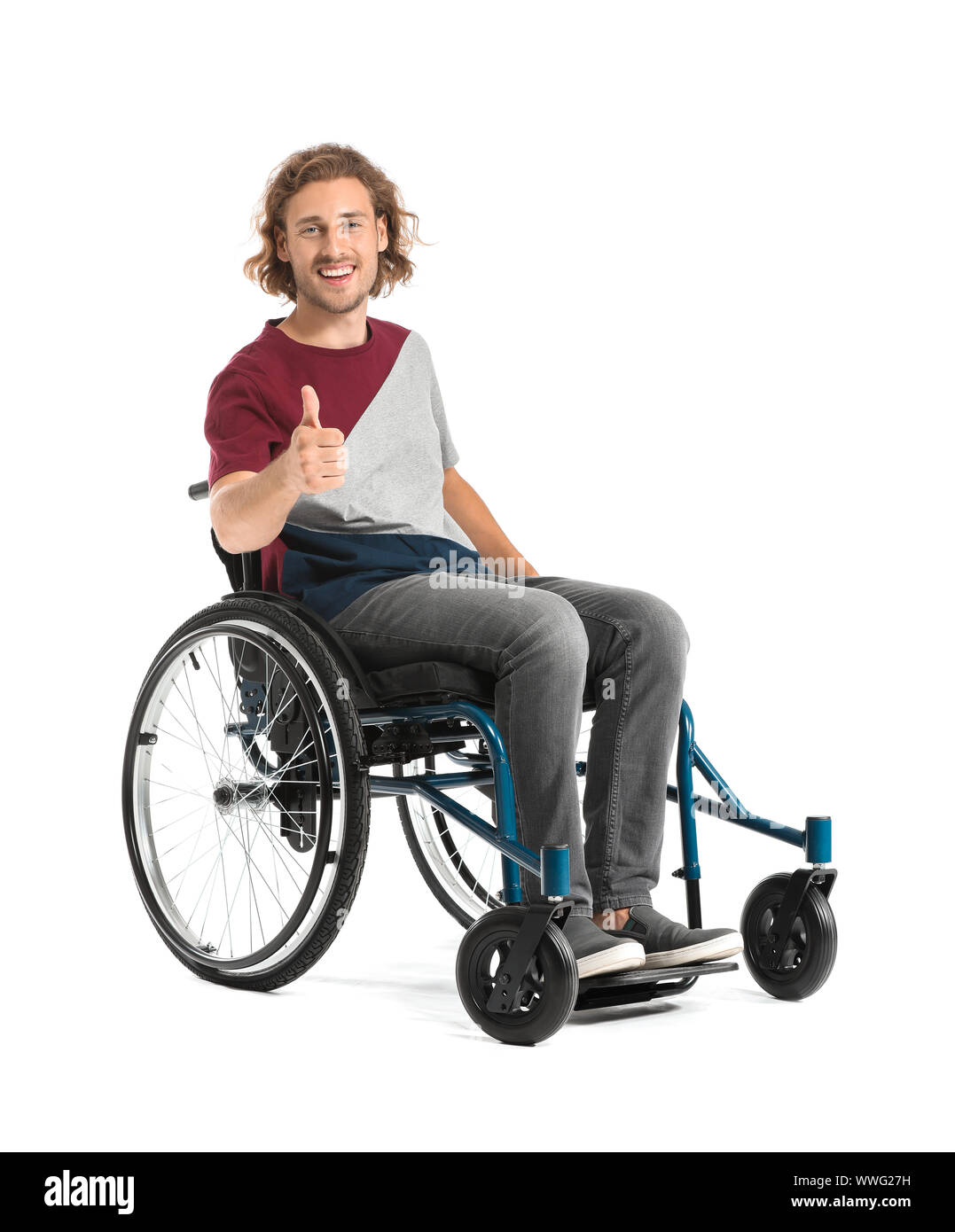Happy man in wheelchair showing thumb-up gesture on white background ...