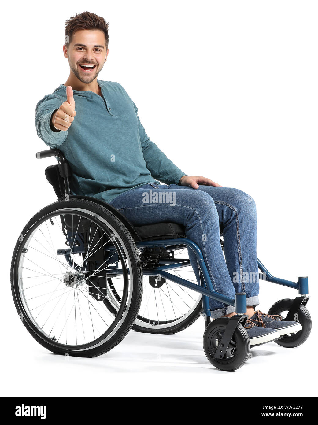 Happy man in wheelchair showing thumbup gesture on white background
