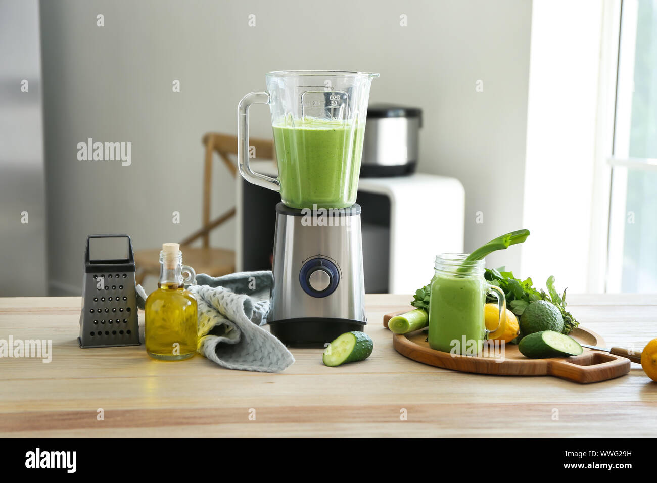 Preparing Of Tasty Smoothie With Blender In Kitchen Stock Photo Alamy