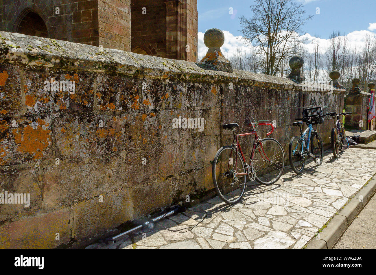 Bicycles parked on the wall the church of Salinas de Pisuerga. Palencia March 2013 Stock Photo