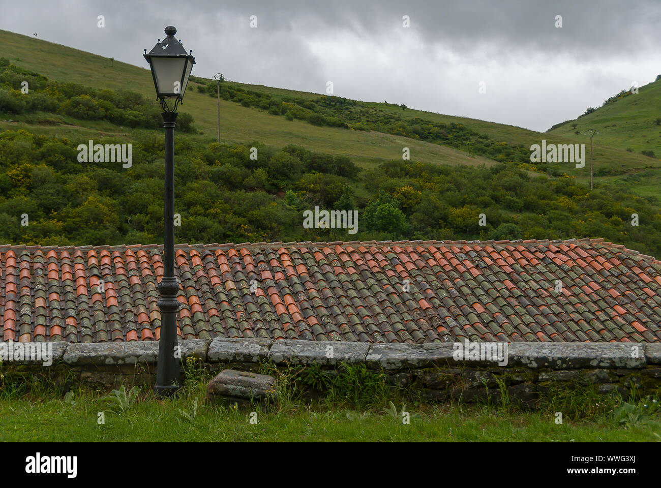 Lamppost, rooftop on green palentina mountain background Stock Photo - Alamy