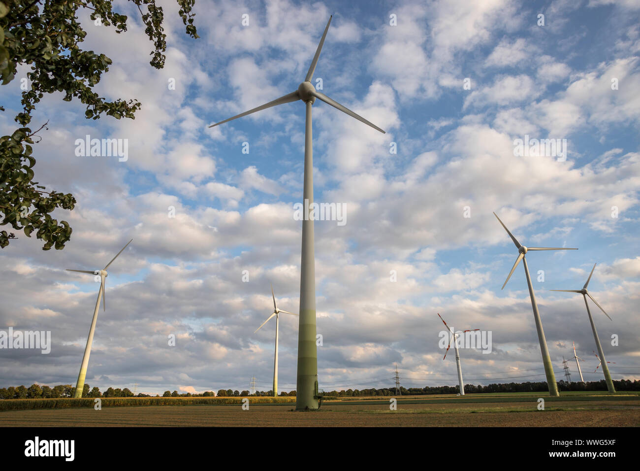 some modern wind turbines in front of a cloudy sky Stock Photo - Alamy