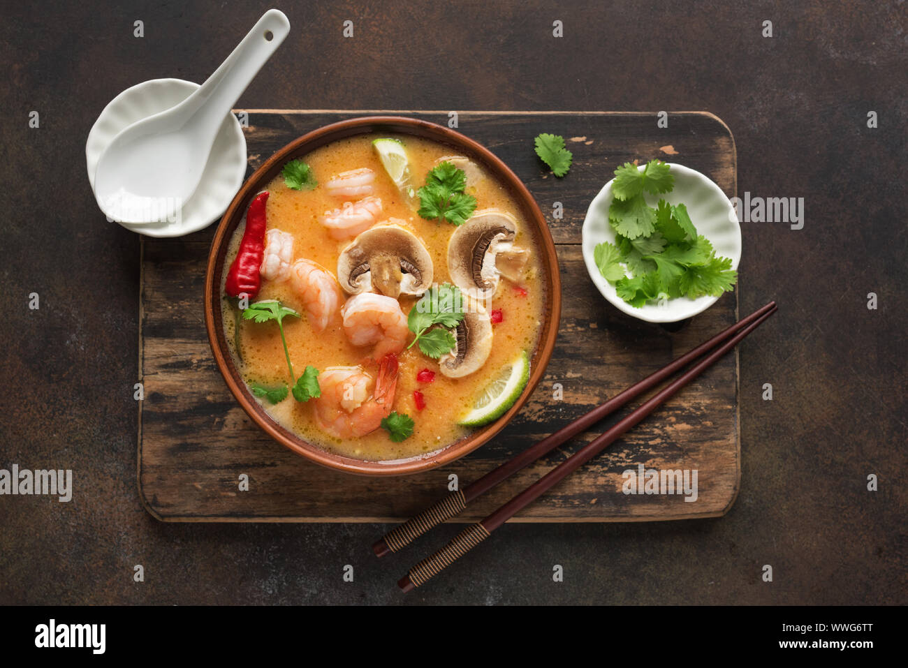 Tom Yum Kung Soup, top view, copy space. Traditional thai asian spicy coconut milk soup with shrimps - tom yam soup. Stock Photo
