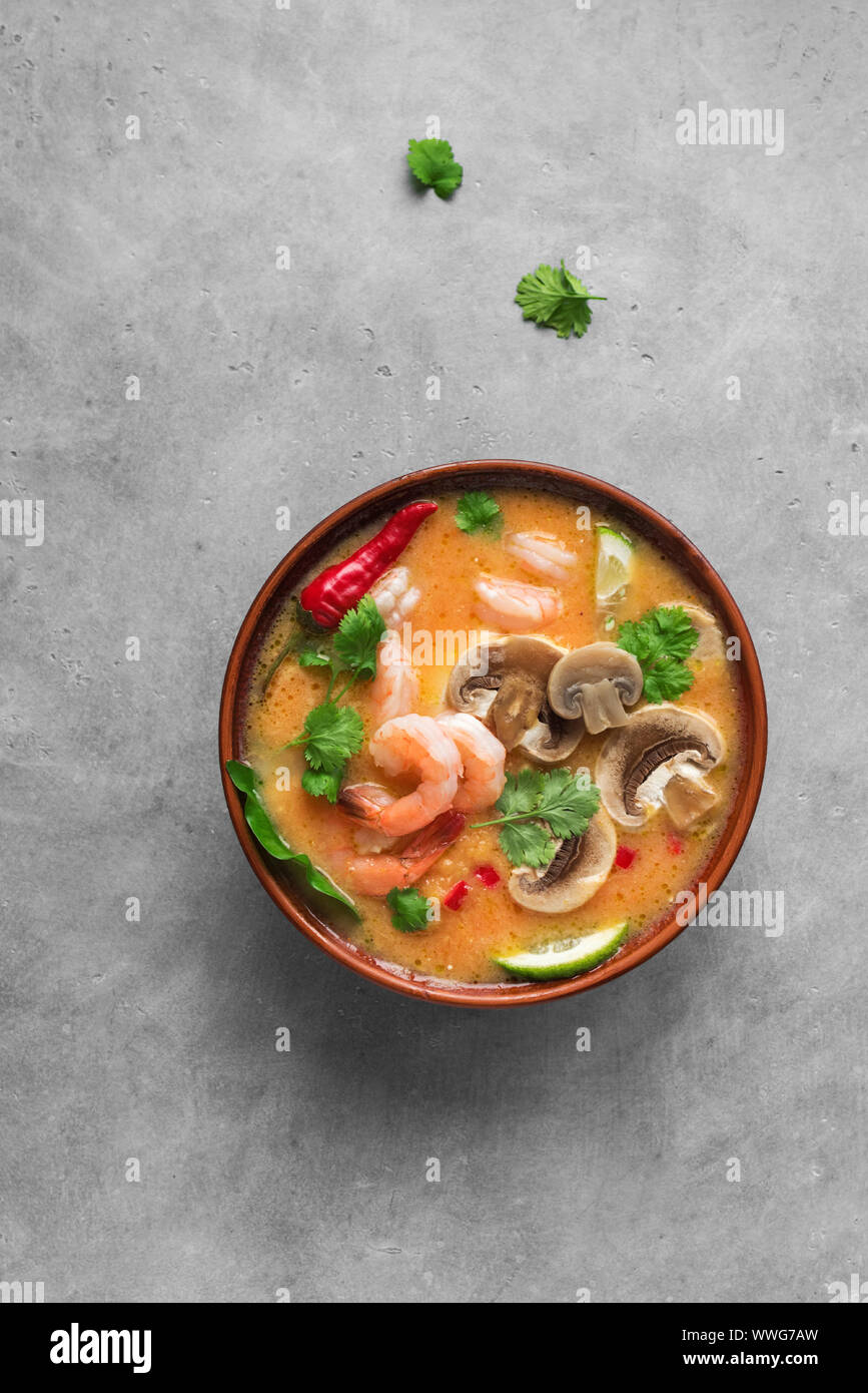 Tom Yum Kung Soup, top view, copy space. Traditional thai asian spicy coconut milk soup with shrimps - tom yam soup. Stock Photo