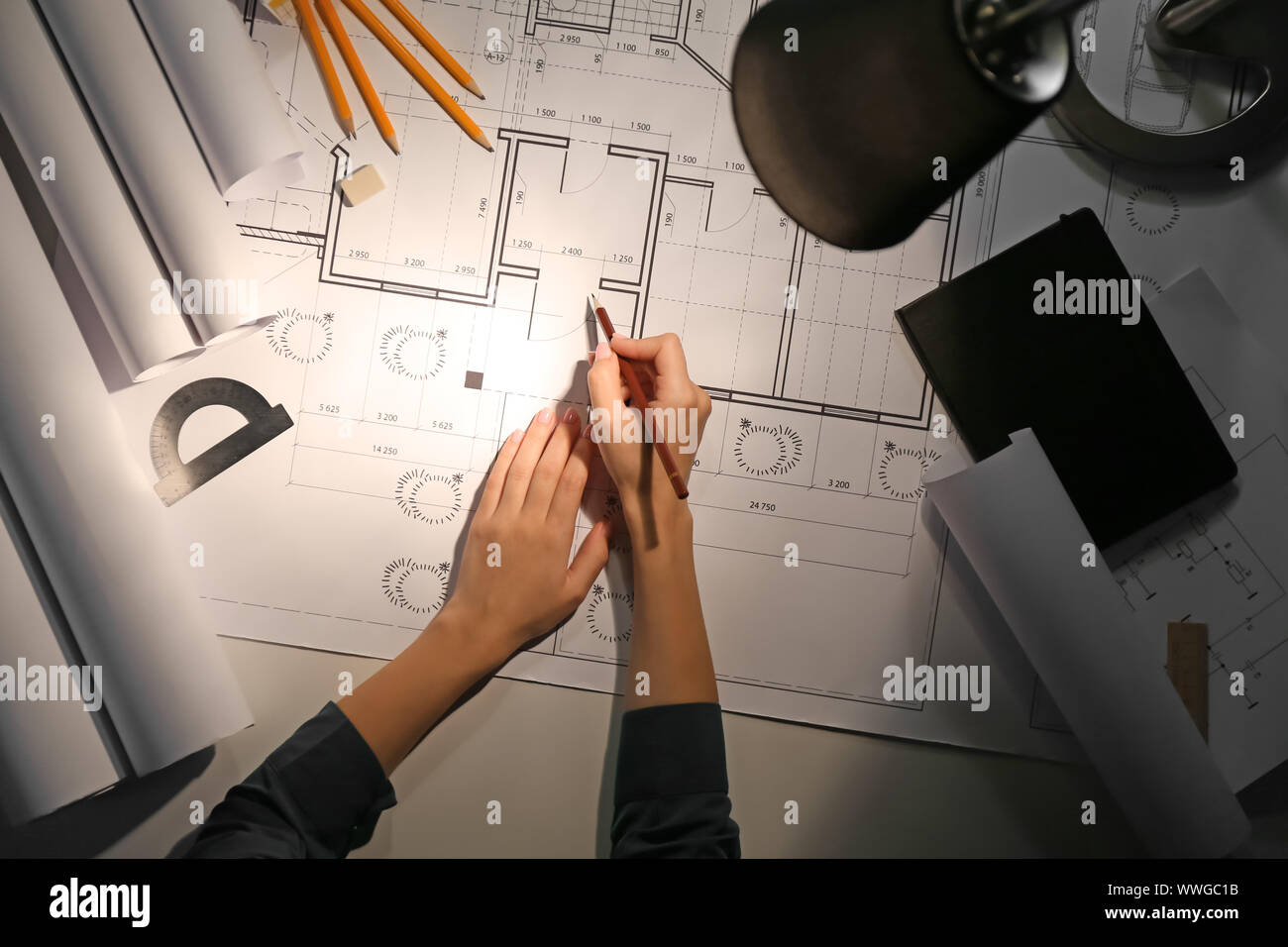 Female architect working late in evening, top view Stock Photo Alamy