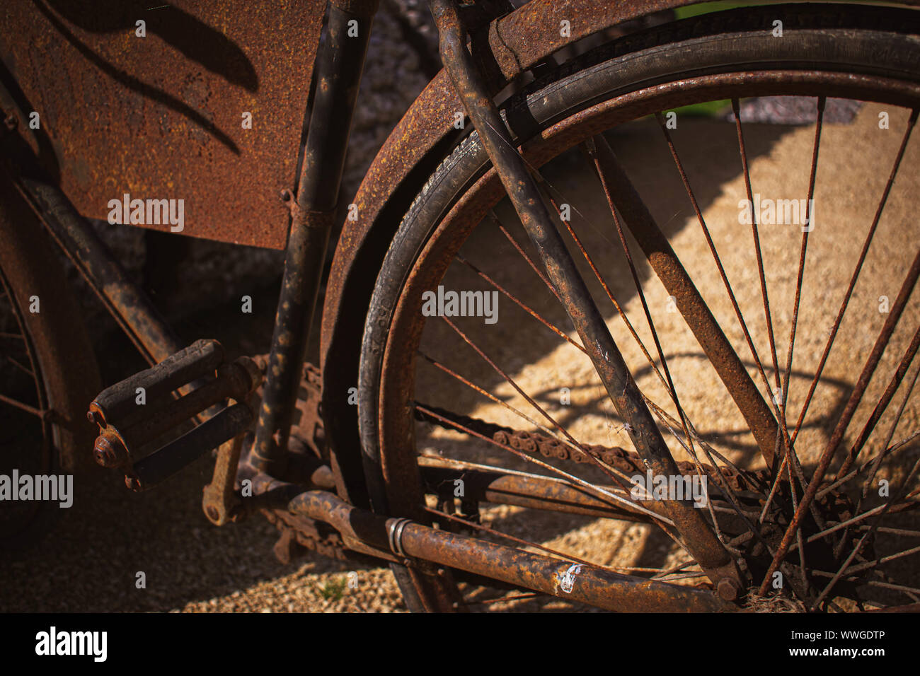 A close up of a rusted antique bike showing lots of age and patina Stock Photo
