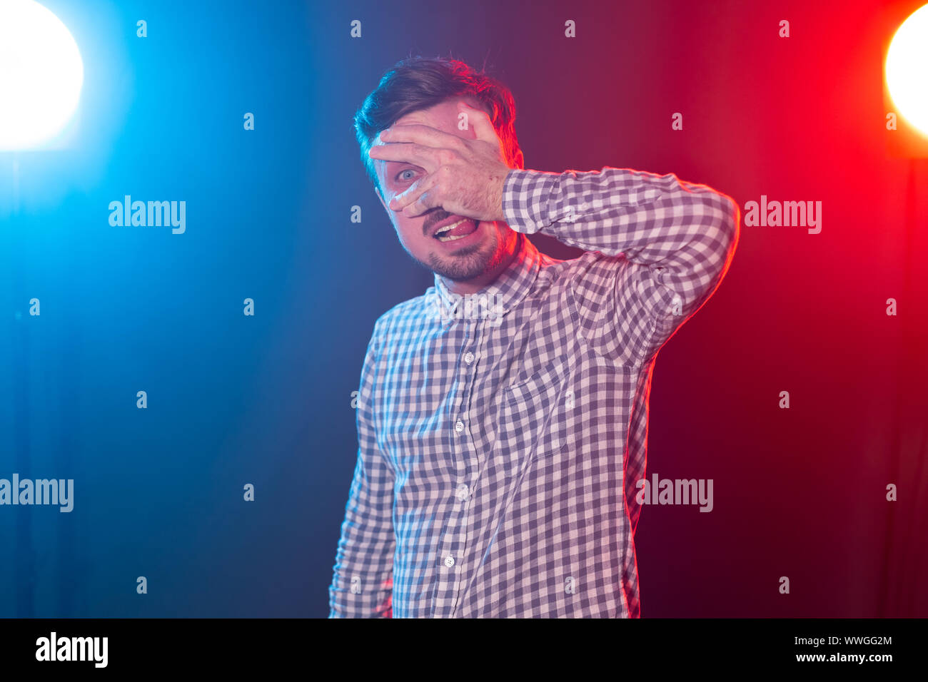 Portrait of funny man with face palm gesture. Disappointed stressed out male making facepalm with hand. Stock Photo