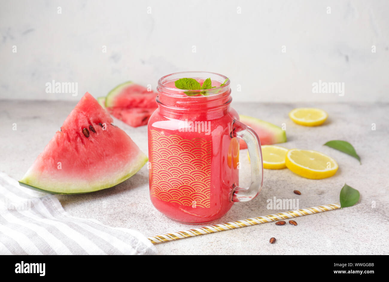 Mason jar of fresh watermelon juice on table Stock Photo - Alamy