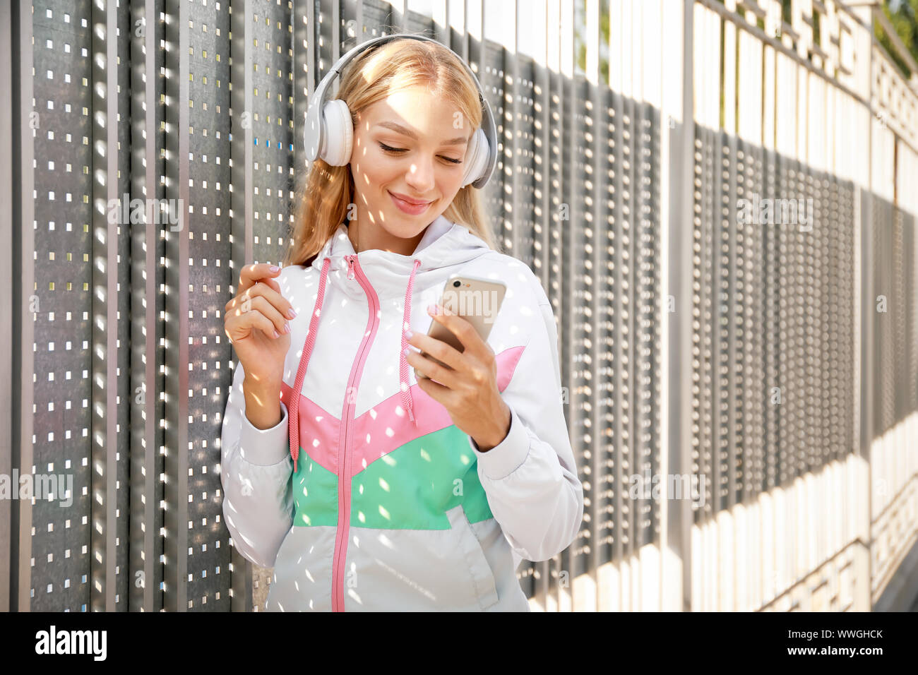 Beautiful young woman listening to music outdoors Stock Photo - Alamy