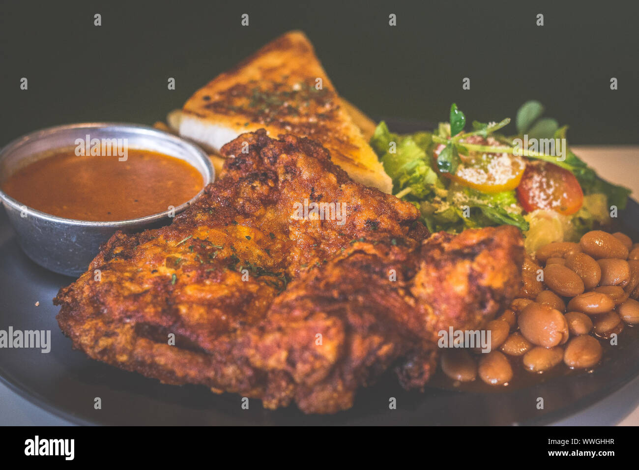Deep fried chicken fillet with toast, sauce, baked beans, french fries and salad Stock Photo Alamy