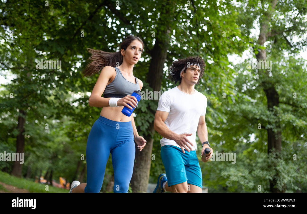 Happy couple running and jogging together outdoor Stock Photo - Alamy