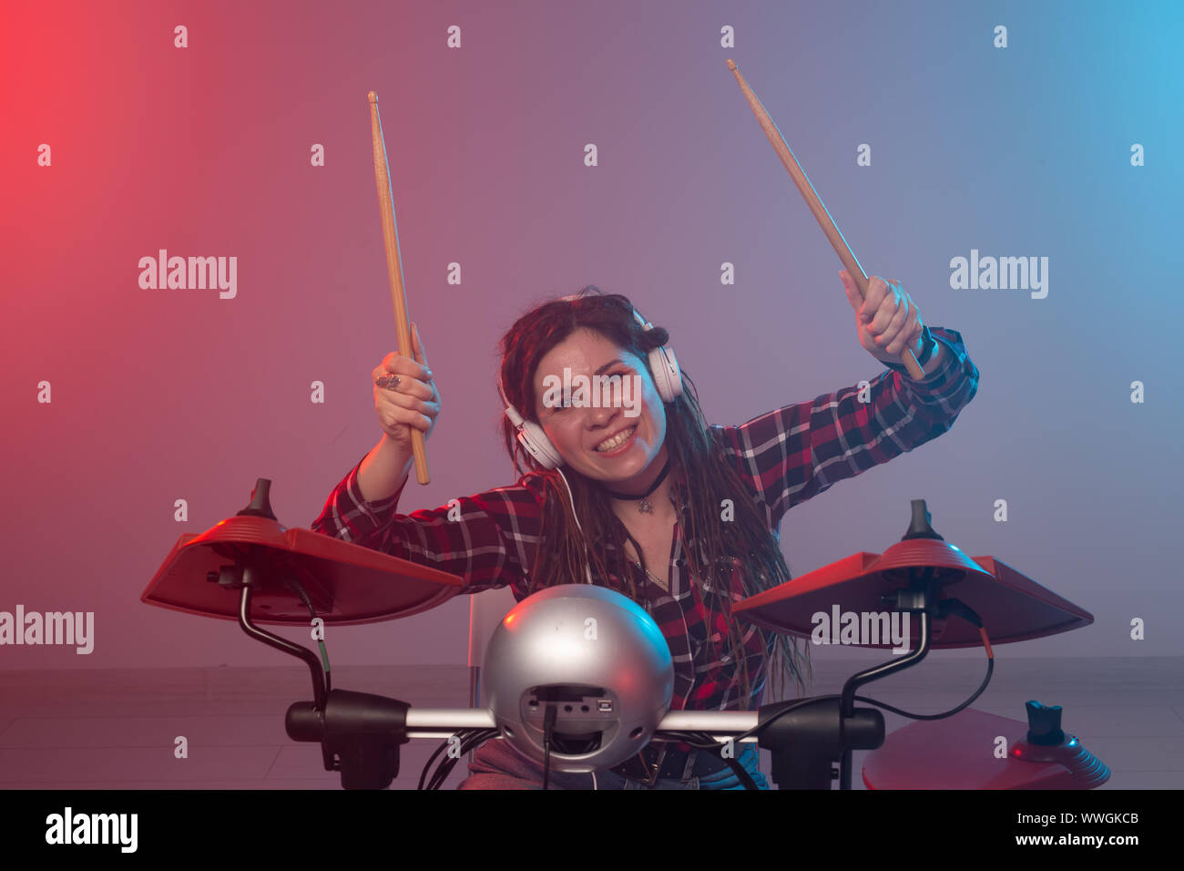 Music, electronic drum set and hobby concept woman drummer in a