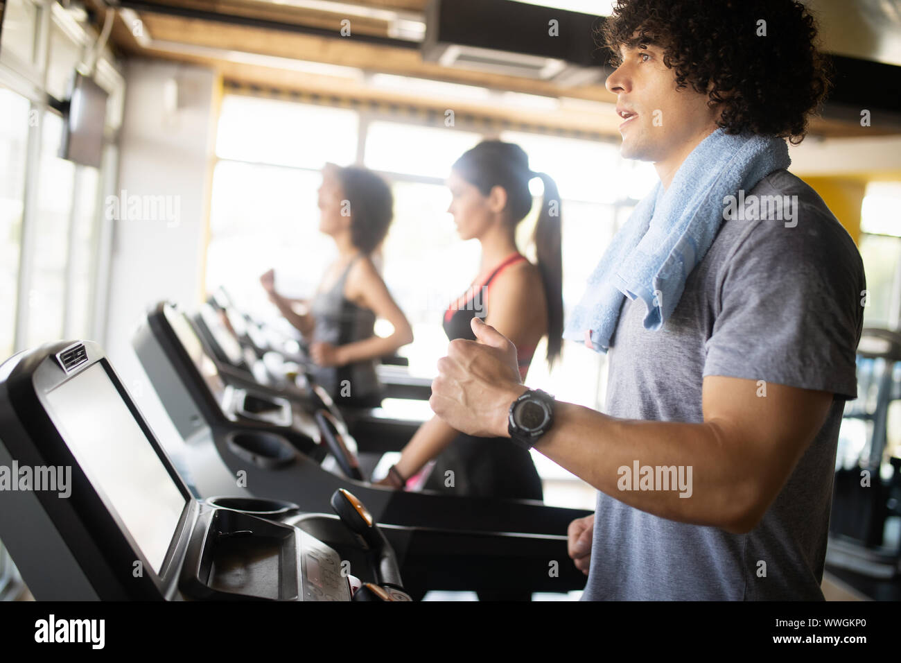 Group of young people running on treadmills in modern sport gym Stock ...