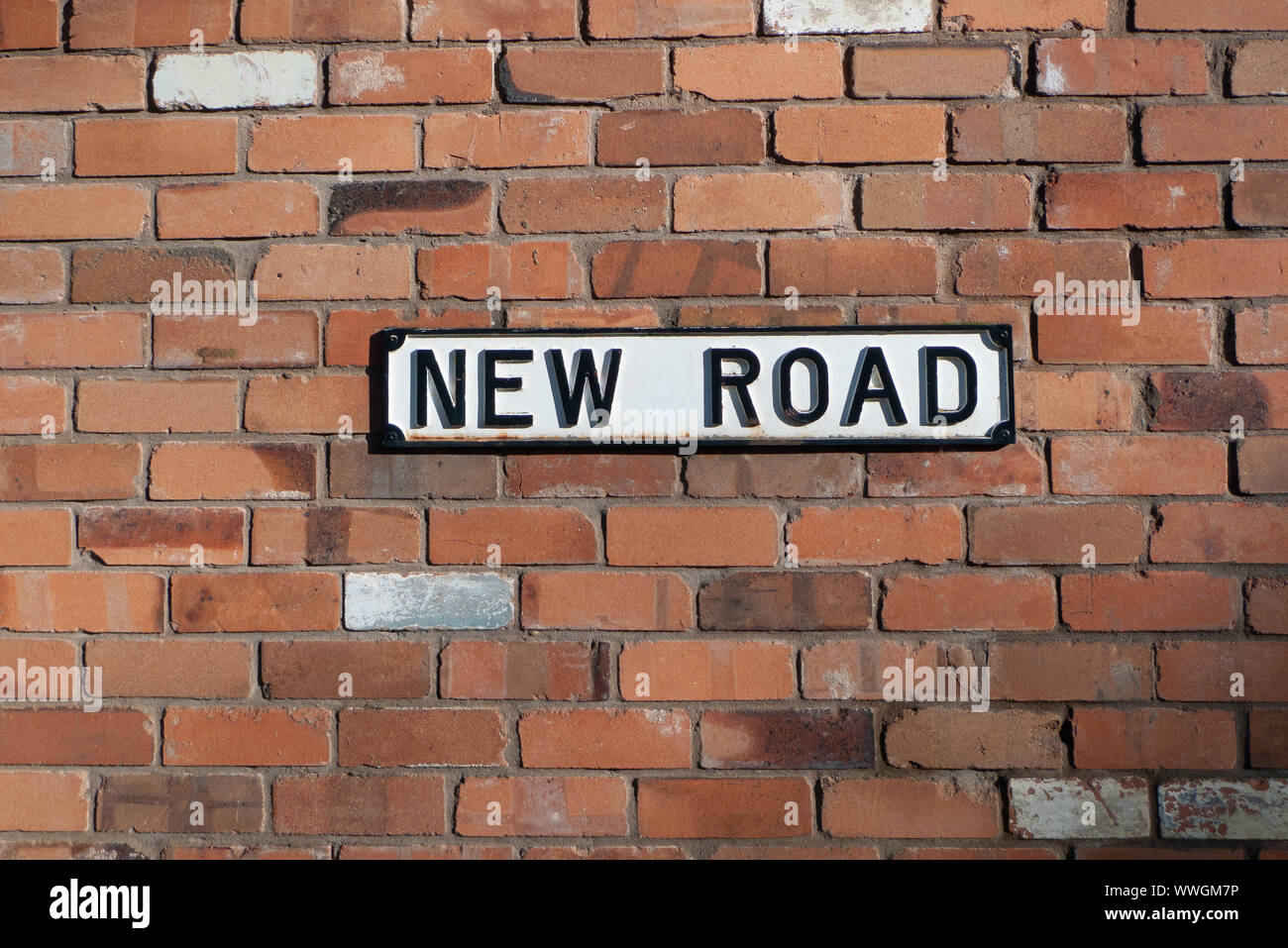 Street sign called 'New Road' on a brick wall Stock Photo Alamy