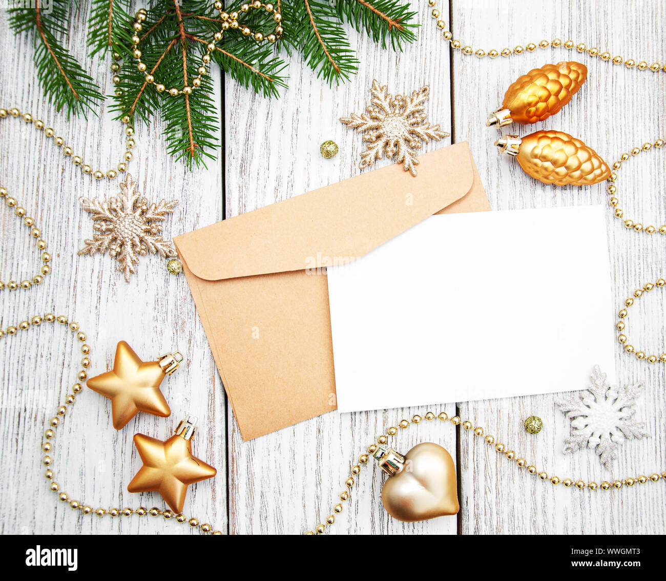 https://c8.alamy.com/comp/WWGMT3/envelope-with-christmas-decoration-on-a-old-wooden-board-WWGMT3.jpg