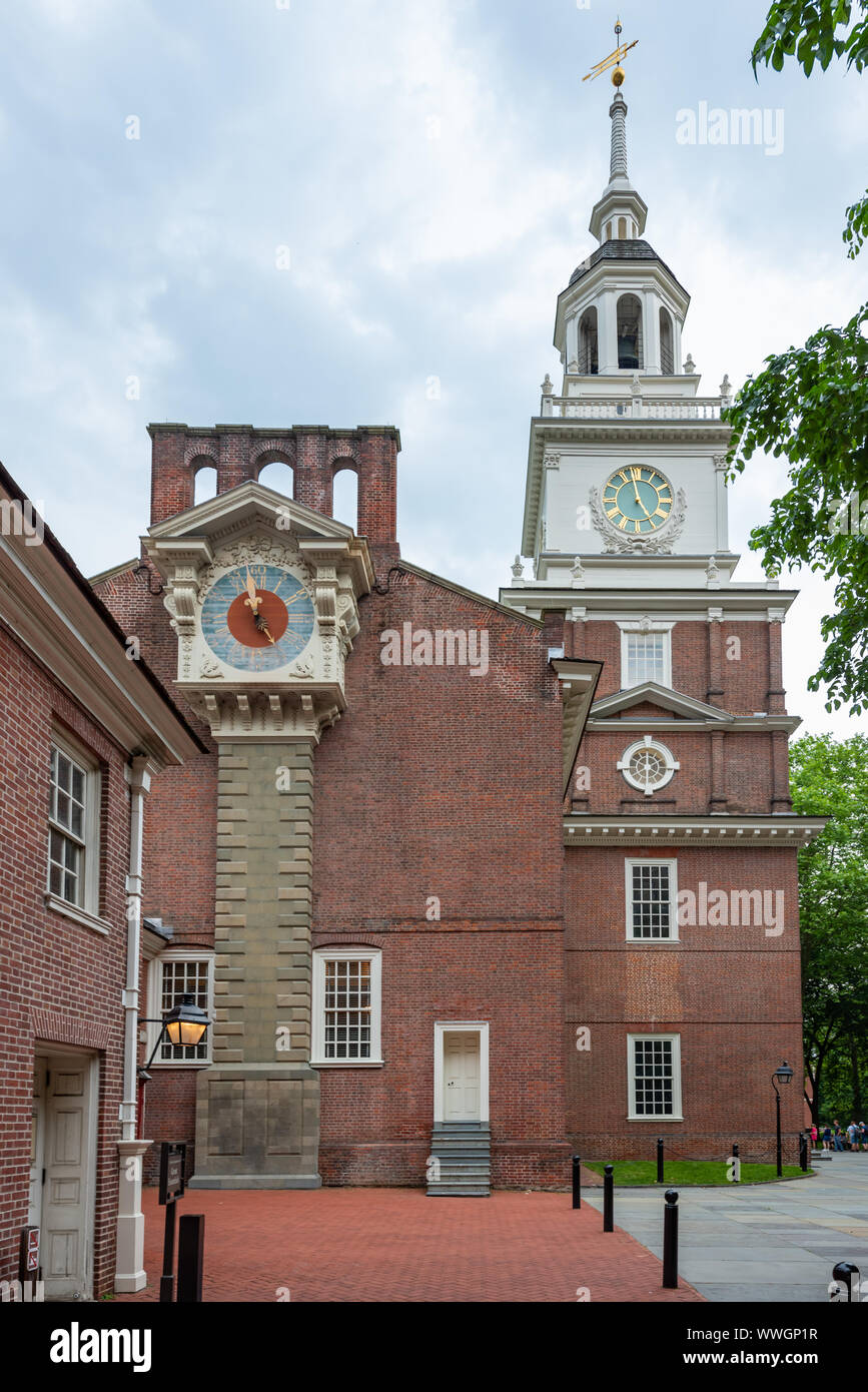 Independence Hall's two clocks. The replica of Thomas Stretch's  grandfather clock restored in 1973 & the clock in William Strickland's 1823 steeple . Stock Photo