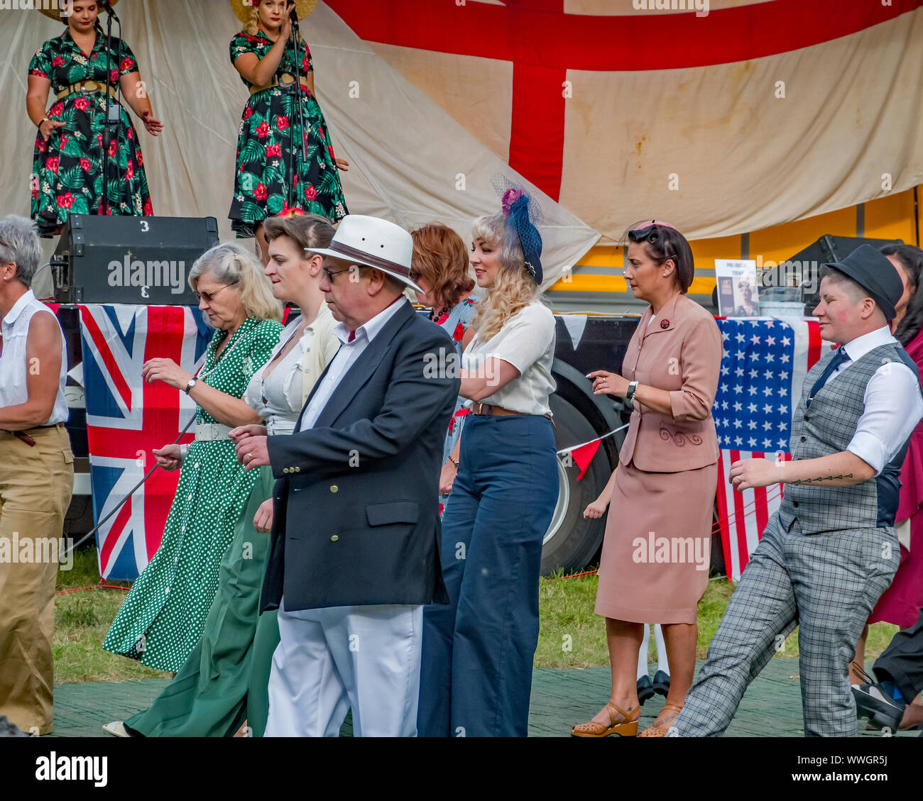 Dance troupe dressed up in 1940s style clothing performs a Charleston dance demonstration at the annual forties weekend in Holt Norfolk Stock Photo