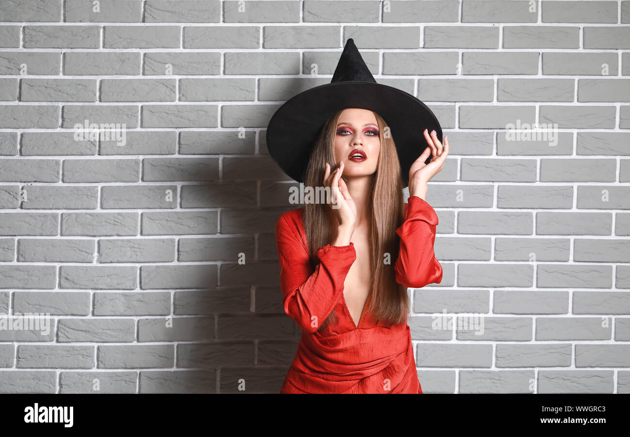 length portrait against a white background of a woman with green body paint  dressed up in a witch costume for Halloween making a scary face at camera  Stock Photo - Alamy