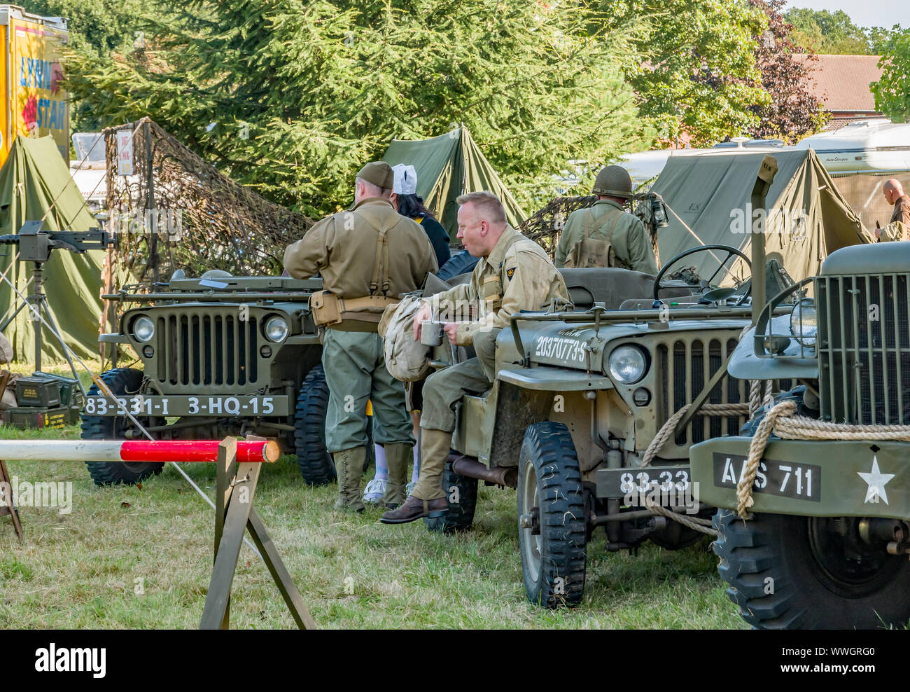 Men dressed in US soldier uniform among US military vehicles during the annual forties weekend in Holt Stock Photo