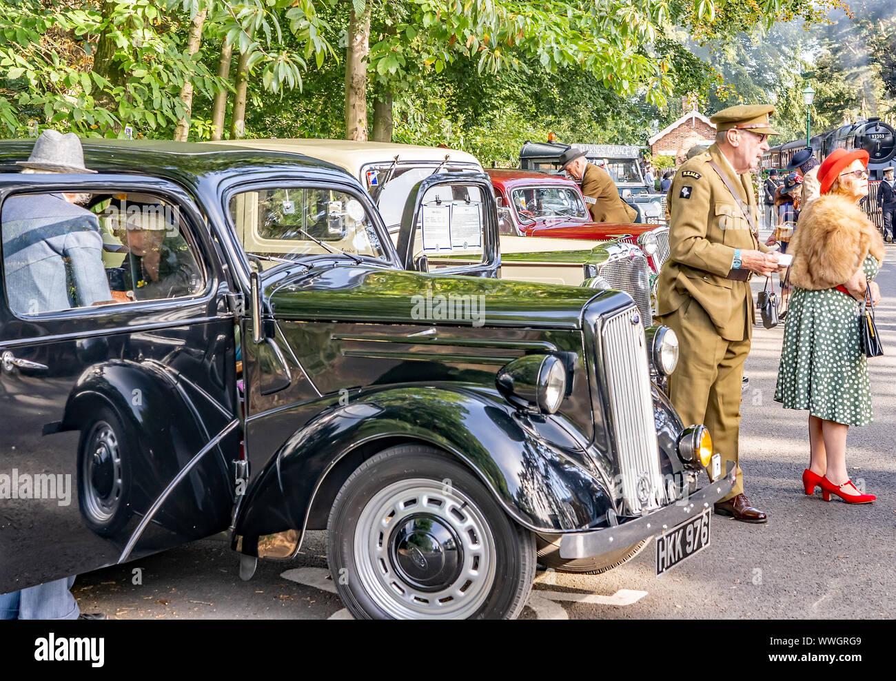 People dressed in 1940s style clothing looking around the classic and