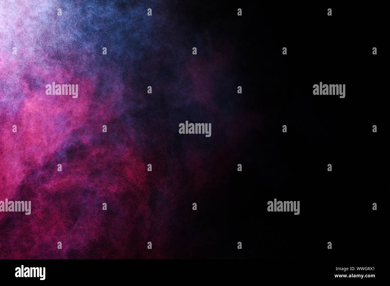 Freeze motion of colored dust explosion isolated on black background. Stock Photo