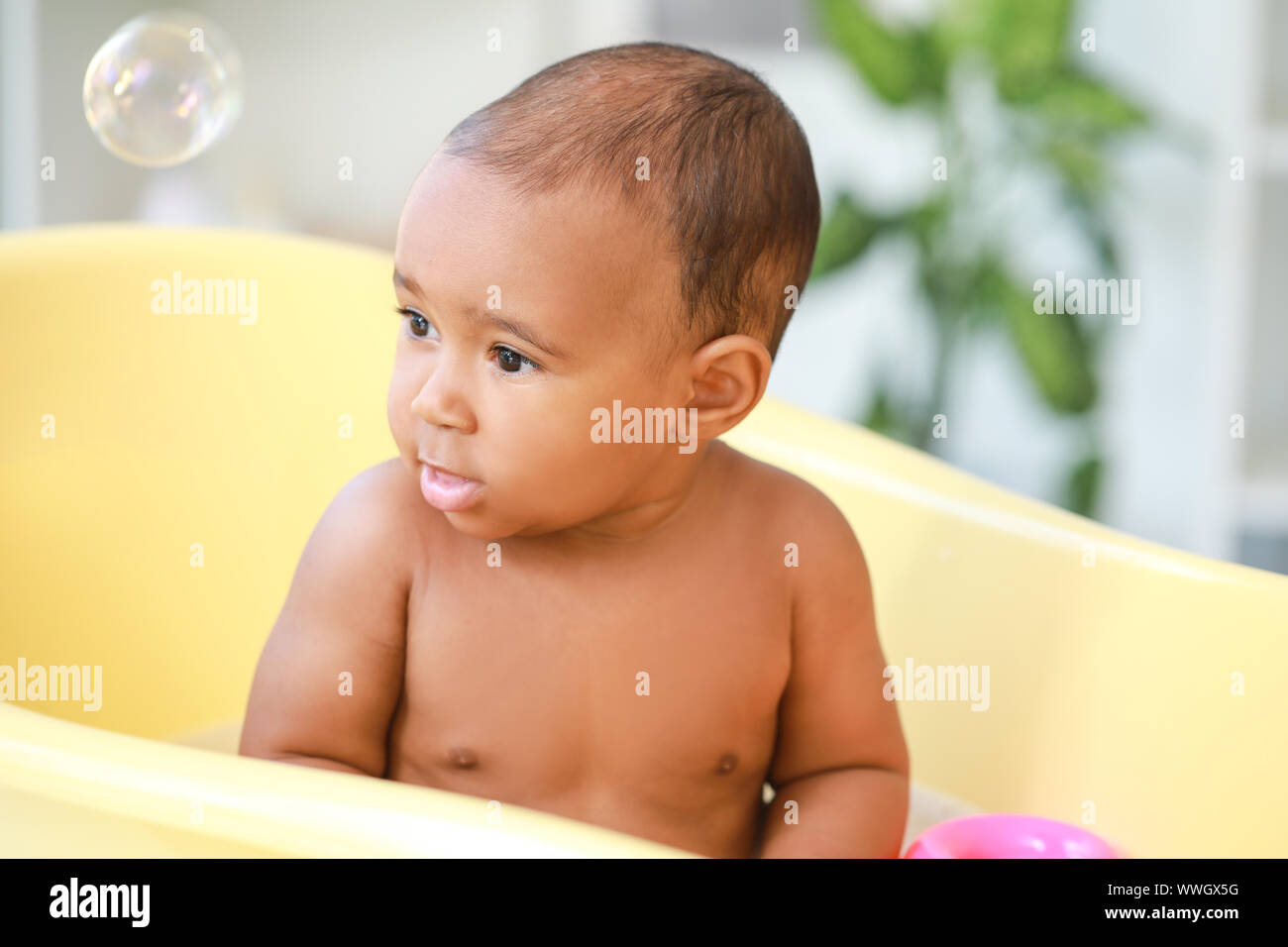 Little AfricanAmerican baby washing in bathtub at home Stock Photo Alamy