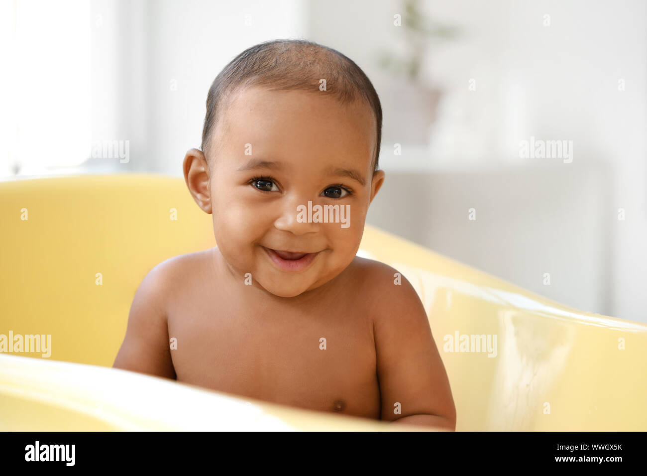 Little AfricanAmerican baby washing in bathtub at home Stock Photo Alamy