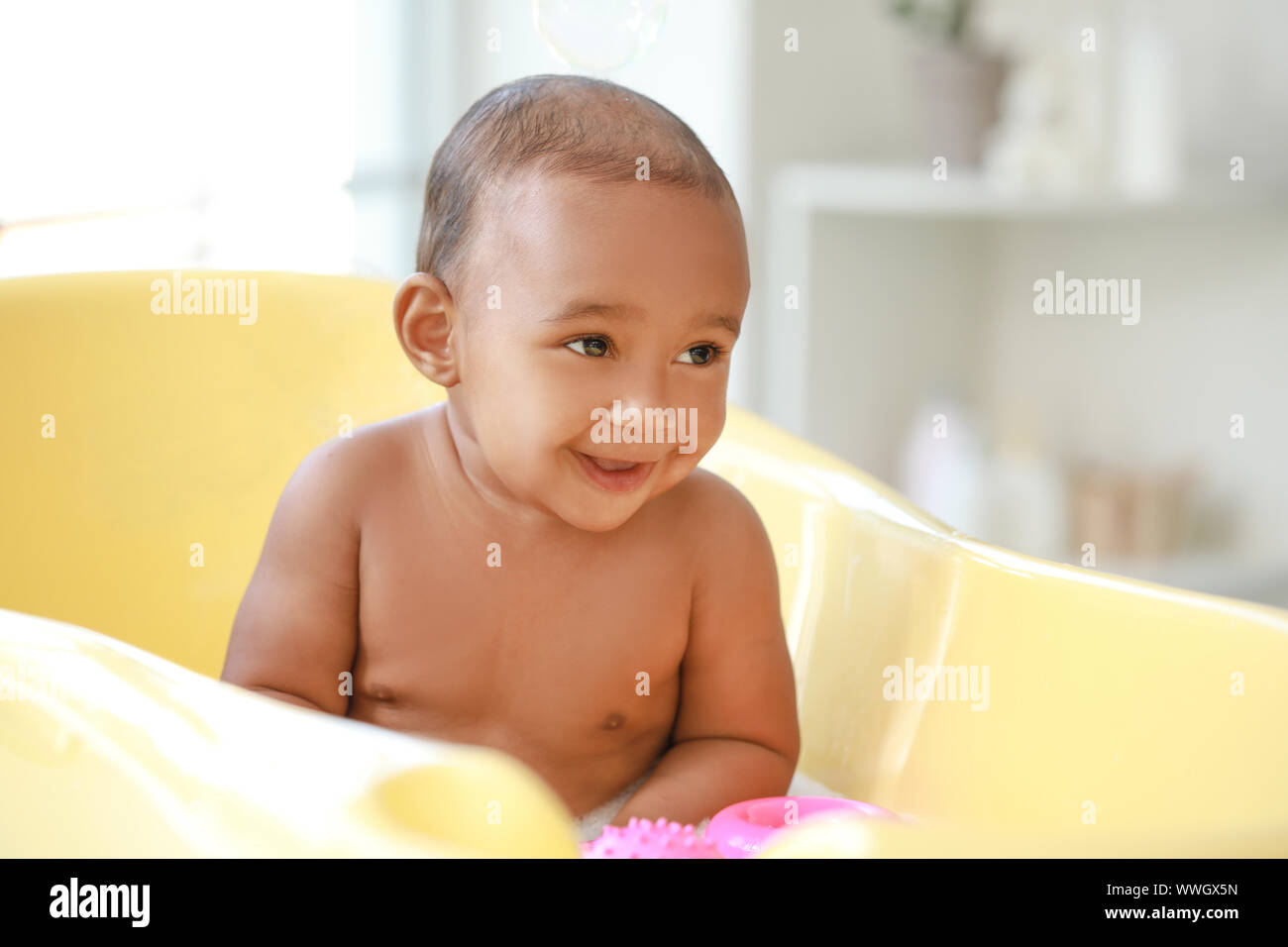 Little AfricanAmerican baby washing in bathtub at home Stock Photo Alamy
