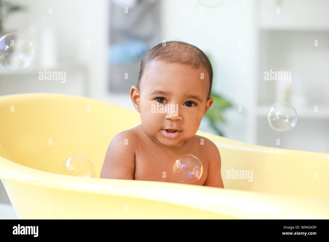 Little AfricanAmerican baby washing in bathtub at home Stock Photo Alamy