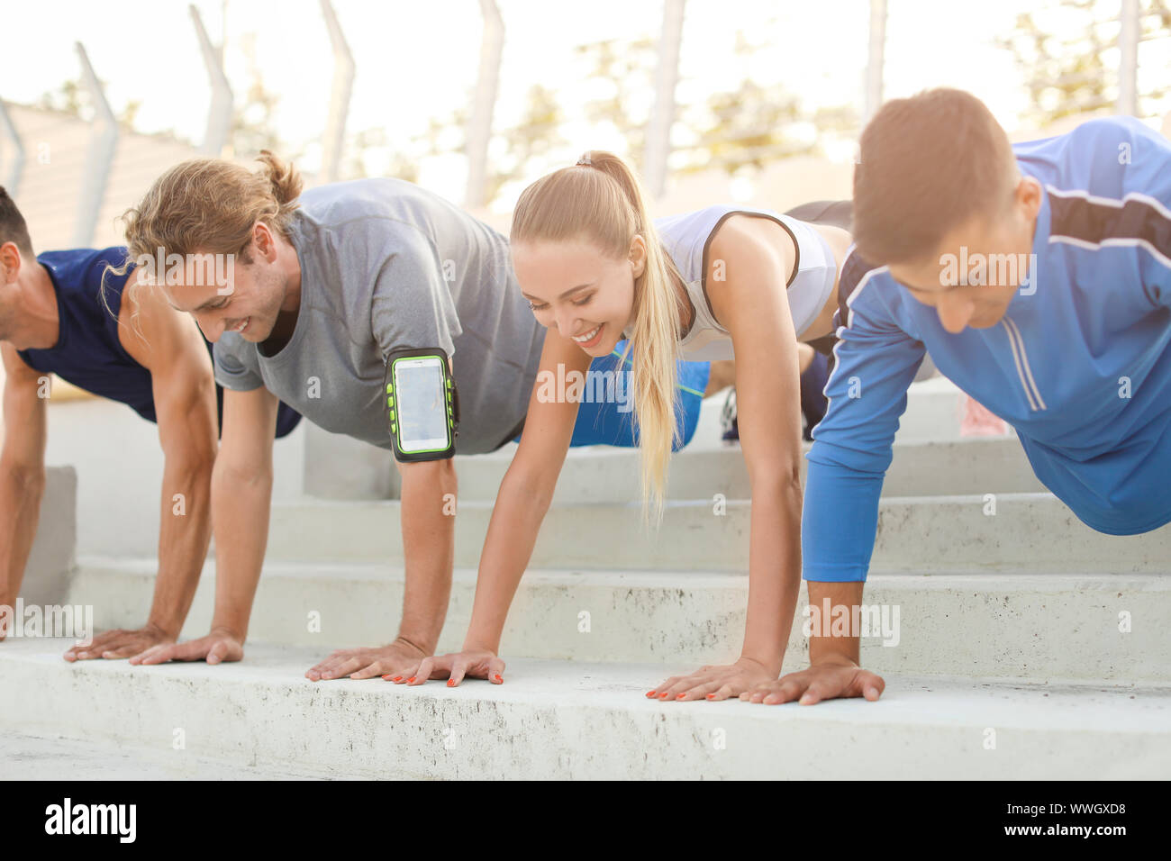 Group of sporty young people training at the stadium Stock Photo - Alamy