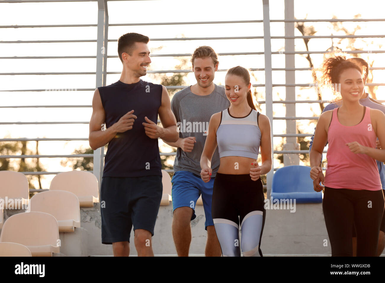 Group of sporty young people training at the stadium Stock Photo - Alamy