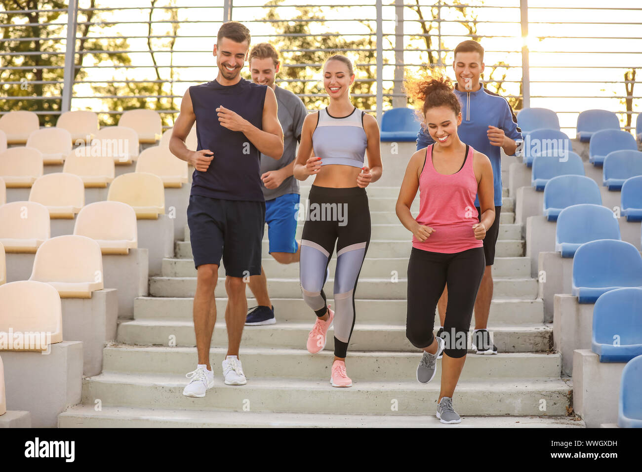 Group of sporty young people training at the stadium Stock Photo - Alamy