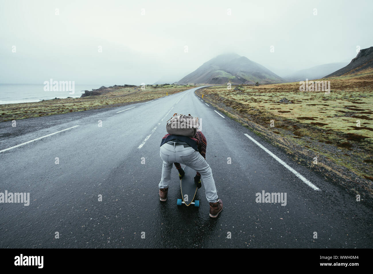 Skater traveling iceland on his longboard Stock Photo - Alamy