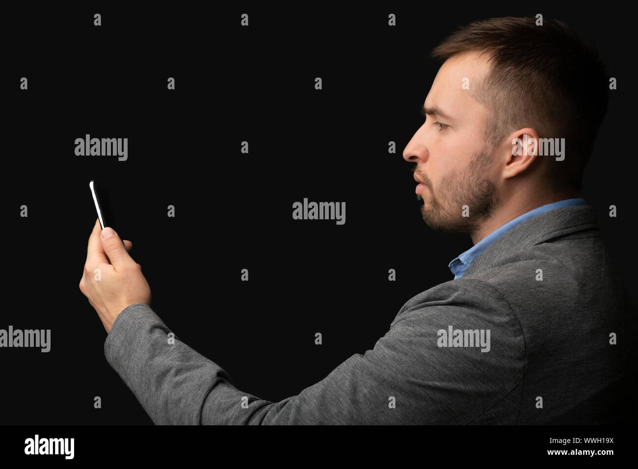 Modern businessman using facial recognition softwear on cellphone Stock Photo