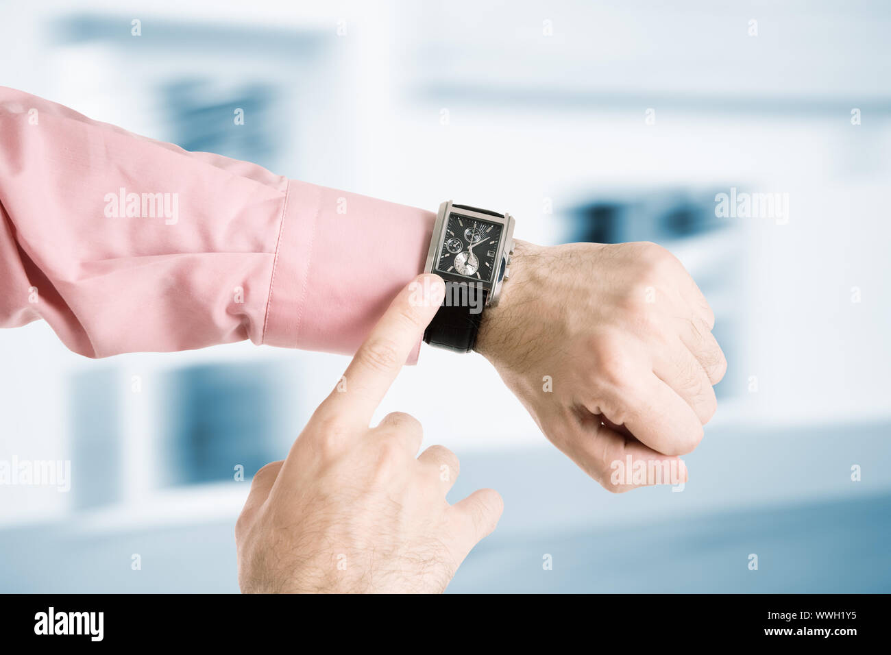 Man Hand Clock hands of the man with clock on urban background Stock Photo - Alamy