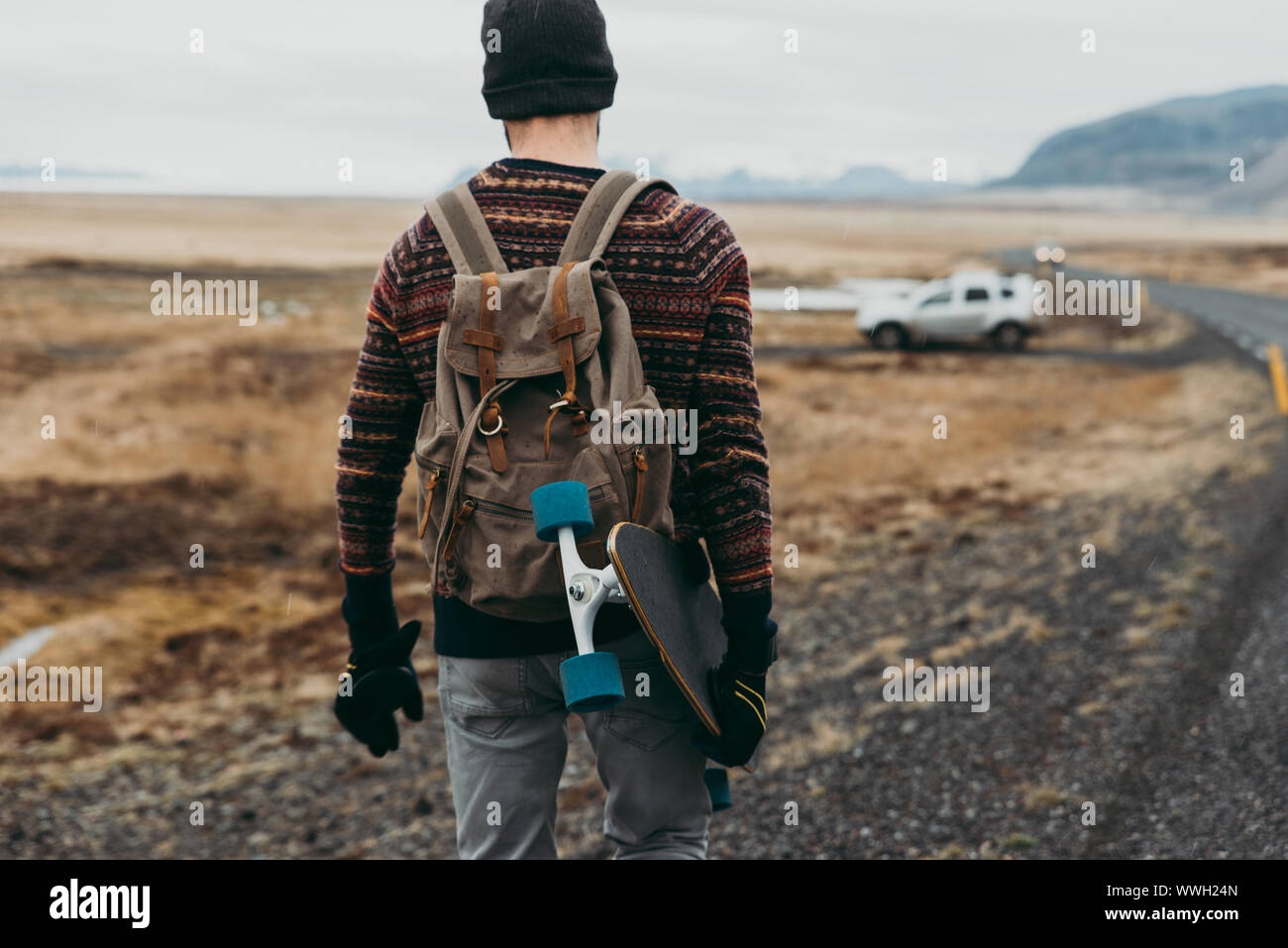 Skater traveling iceland on his longboard Stock Photo - Alamy