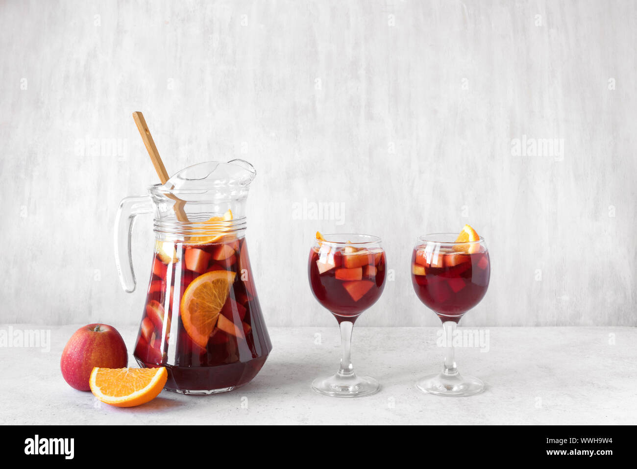 red-wine-sangria-or-punch-with-fruits-and-ice-in-glasses-and-pitcher