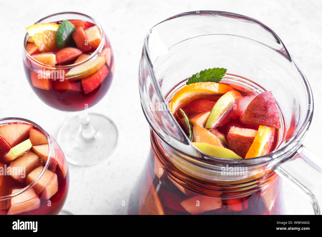 red-wine-sangria-or-punch-with-fruits-and-ice-in-glasses-and-pitcher
